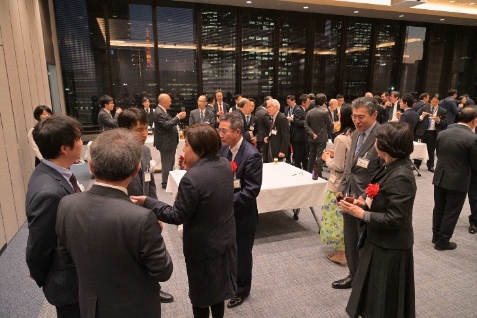 Participants networking at the post-meeting reception